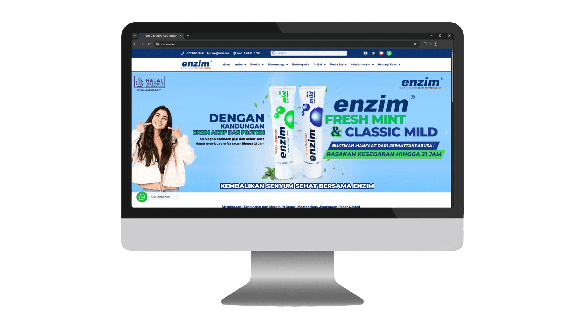 Desktop monitor displaying the Enzim toothpaste website homepage, featuring a blue promotional banner for "Fresh Mint & Classic Mild" with images of two toothpaste tubes, a smiling woman pointing to her mouth, and the Enzim logo.