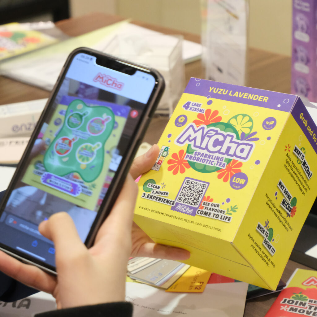 A phone scanning a micha packaging box in hand