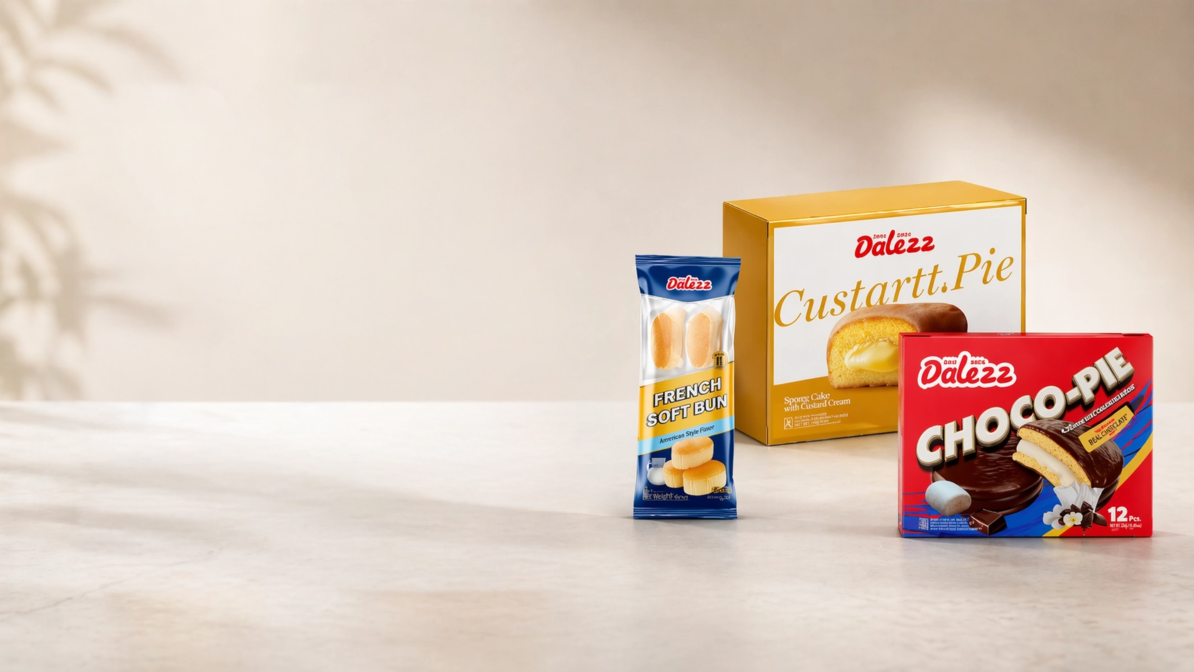 A product display featuring packaged Dalezz snacks, including a blue pack of French Soft Bun, a large yellow box of Custart Pie, and a red box of Choco-Pie on a neutral surface.